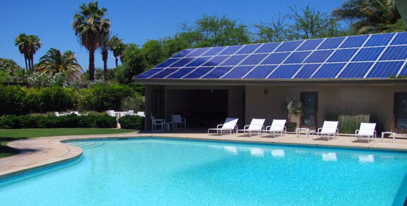 house with large swiming pool and solar panels